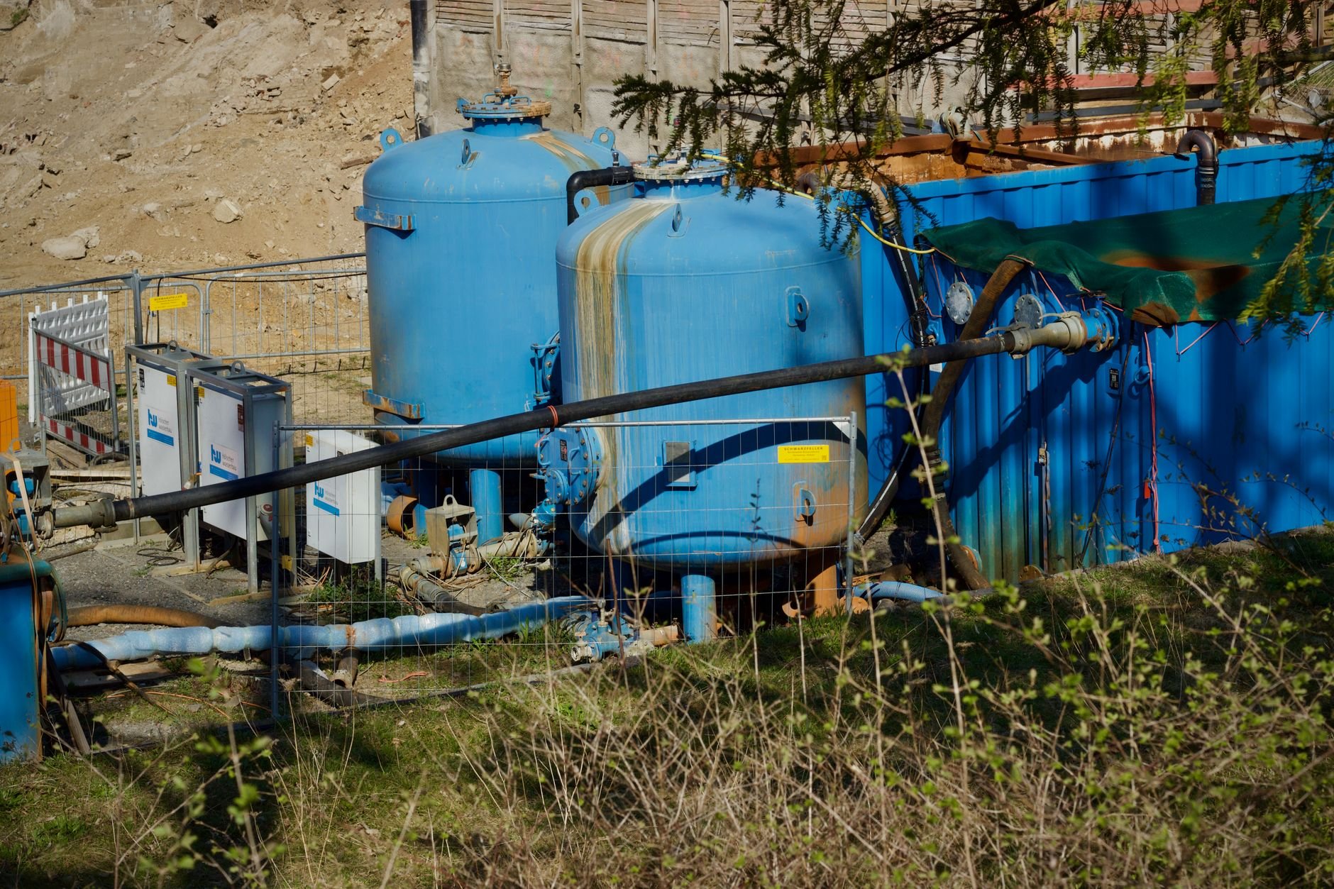 Outdoor industrial water filtration plant with large blue membrane tanks