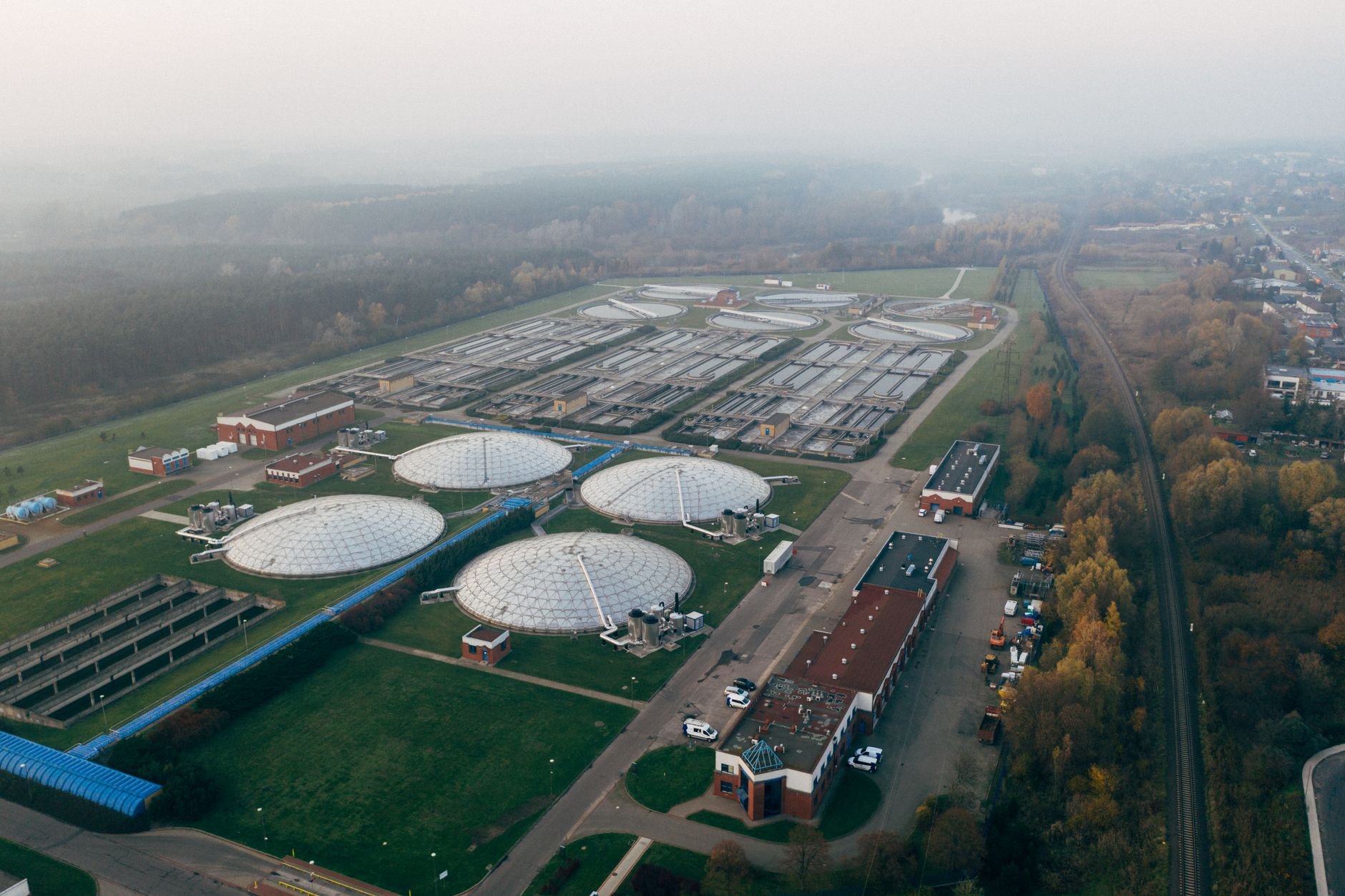 Aerial view of wastewater treatment facility showing large aeration basins
