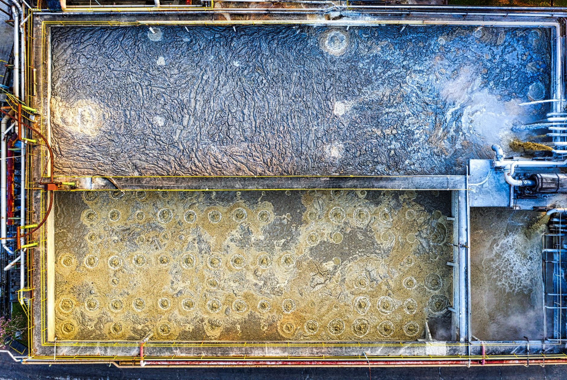 Aerial shot of an industrial water treatment plant with aeration tanks and machinery