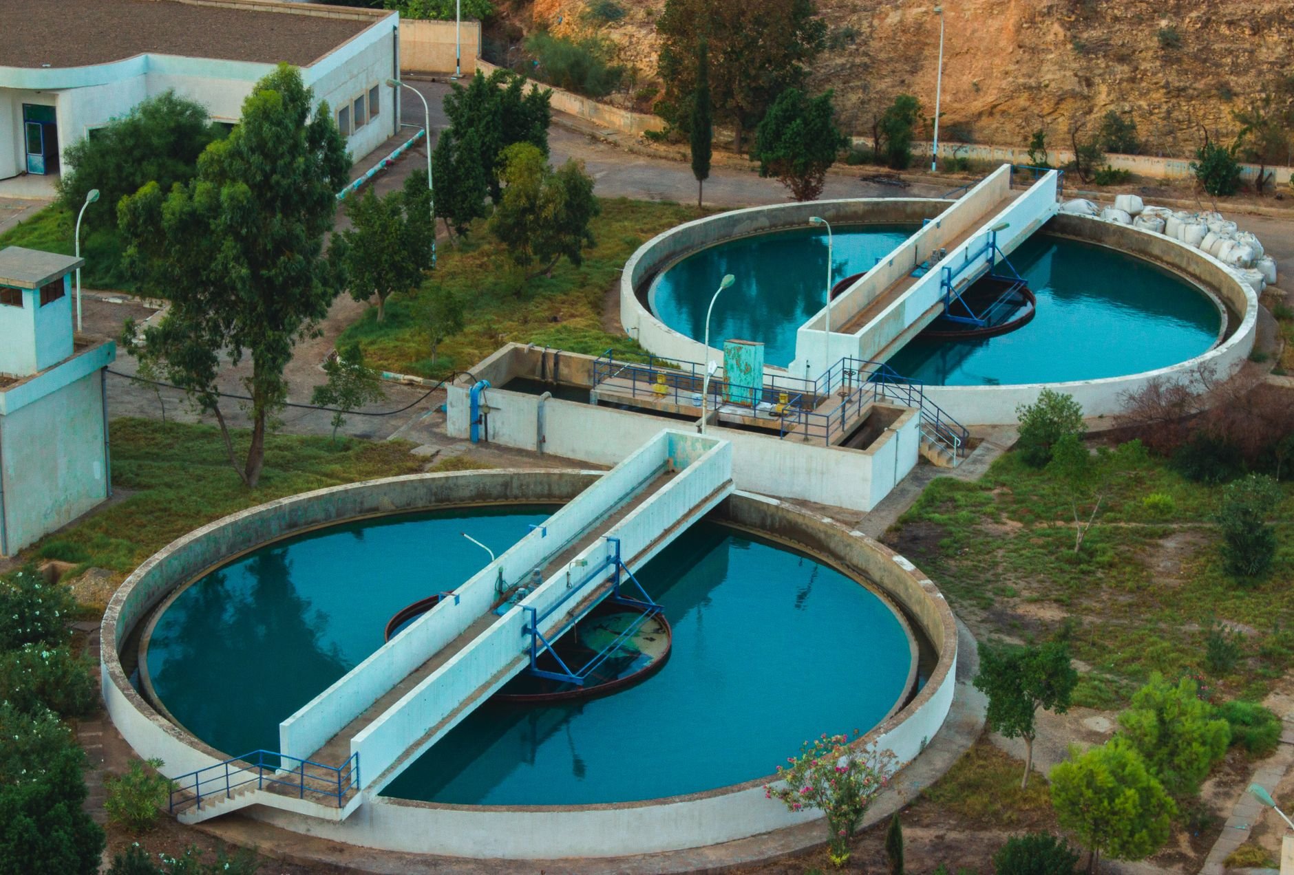 Aerial drone view of advanced water purification plant surrounded by greenery